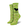 Lime green crew socks with a repeating pattern of sheep, fences, and a black silhouette of a dog. Text says 'Farm Girl'.