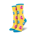 Pair of crew socks featuring a pattern of pink and blue chicks on a yellow background. Teal cuff detail.