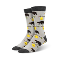 Pair of crew socks in grey and featuring black bears and yellow honeycombs on a light grey background.