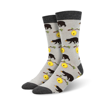 crew-length bamboo socks with black bears climbing on yellow and black striped beehives surrounded by green leaves.  