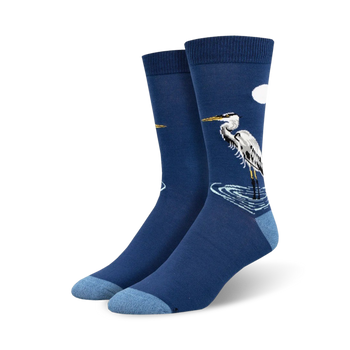 dark blue crew socks for men featuring a pattern of a graceful egret standing in shimmering light blue waters under a golden crescent moon.  