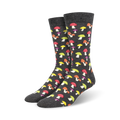 A pair of charcoal grey crew socks adorned with a colorful mushroom pattern. The mushrooms are in shades of red, yellow, and purple.