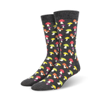 A pair of charcoal grey crew socks adorned with a colorful mushroom pattern. The mushrooms are in shades of red, yellow, and purple.