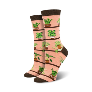 pink crew socks with green houseplants in brown pots, including snake plant, zz plant, and pothos designs.  