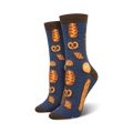 Pair of women's crew socks.  Navy blue with brown-topped cuff. Features repeating pattern of pretzels, croissants, and other baked goods in orange-gold.