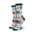 Pair of women's crew socks, light blue with orange squirrels and acorns. Dark green cuffs.