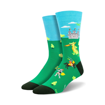 mens crew socks with medieval knight & dragon graphic design, green pixelated trees & black toe on one sock, blue pixelated clouds & sky on other   