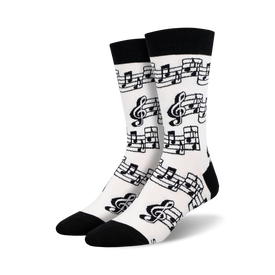 black treble clefs and eighth notes on white background; crew socks designed for men; music-themed.  