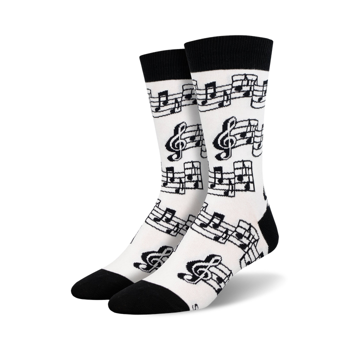 black treble clefs and eighth notes on white background; crew socks designed for men; music-themed.   }}