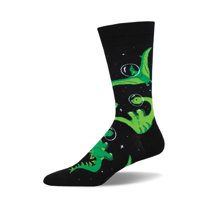 socks that are black and have a pattern of dinosaurs in space. the dinosaurs are green and there are stars and planets in the background. }}