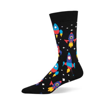 the black socks have a pattern of rockets. the rockets are red, blue, yellow, and green with portholes. there are also white stars and yellow and orange planets.