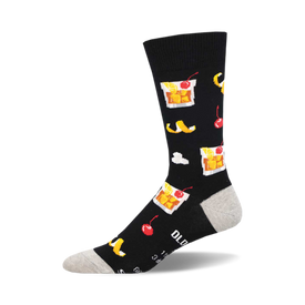 socks that are black with a pattern of lemons, cherries, ice cubes, and glasses with amber liquid.