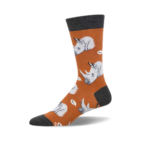 socks that are orange with gray toes, heels, and cuffs. socks with a pattern of cartoonish rhinos wearing party hats and holding a knife and fork. the rhinos are on a white cloud and have speech bubbles that say "no."