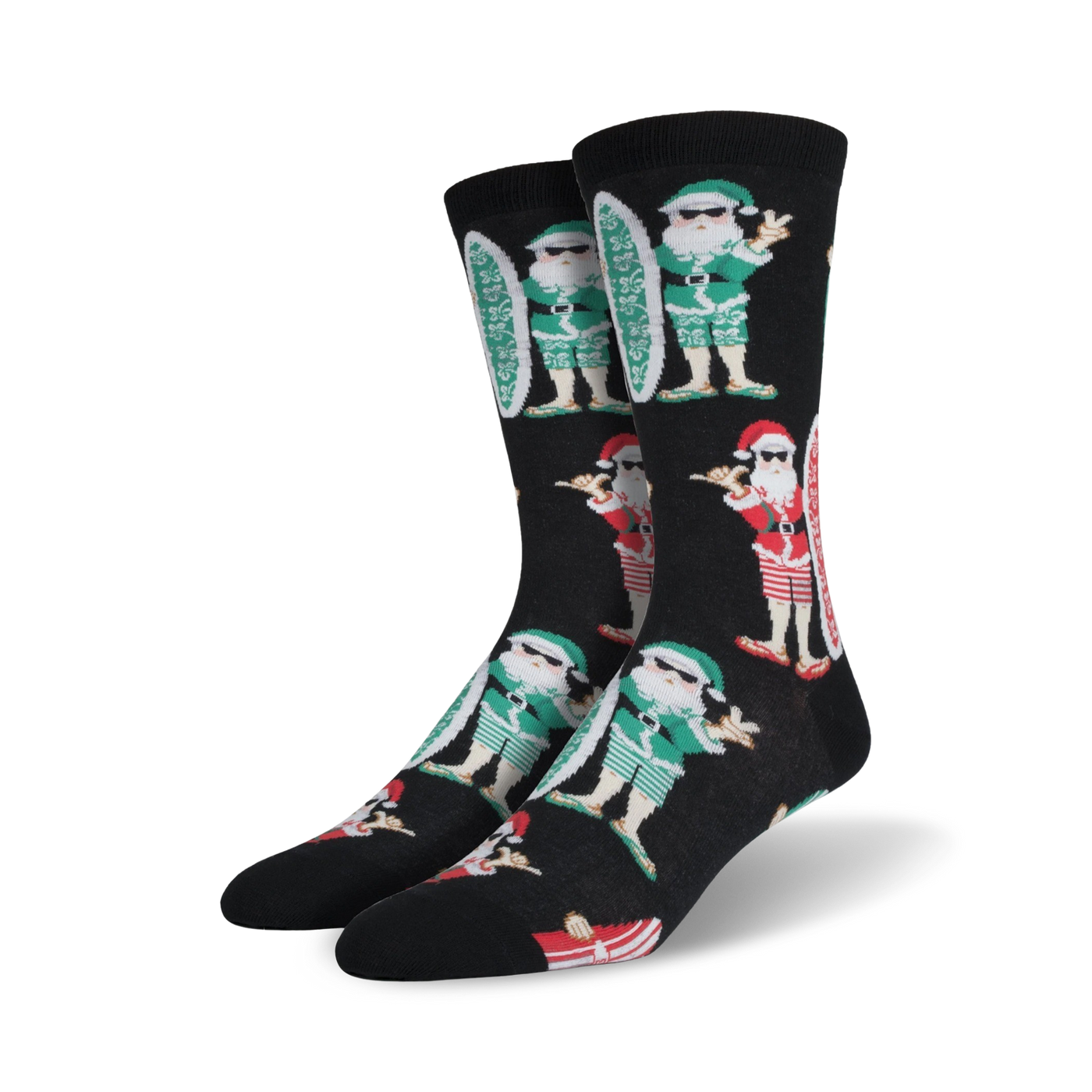 A pair of black crew socks with a repeating pattern of Santa Claus characters surfing.  Santa wears green and red, and the socks have a fun, Christmas-themed design.