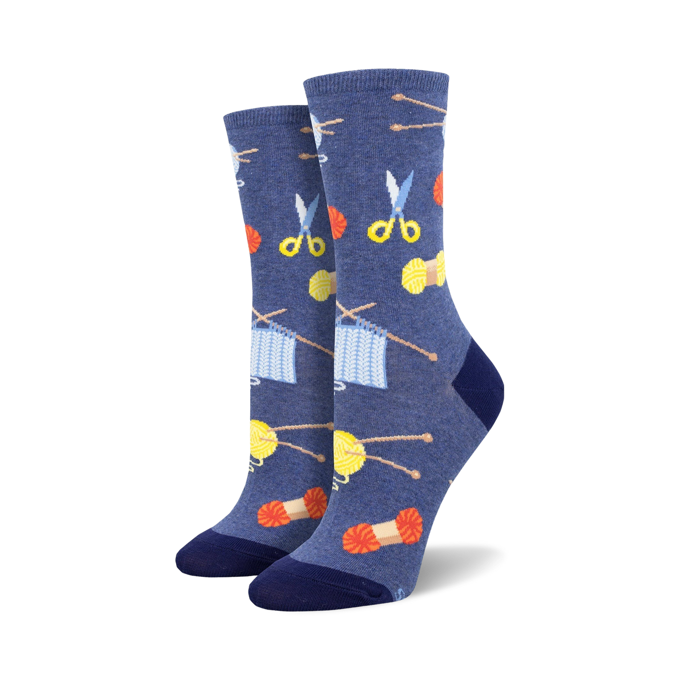 A pair of women's crew socks in blue featuring knitting needles, yarn, and scissors. The design is colorful and fun!