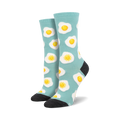 Pair of teal crew socks with a repeating pattern of sunny-side up fried eggs.  Yellow yolks and white egg whites on a light teal background.  Dark grey heel and toe.