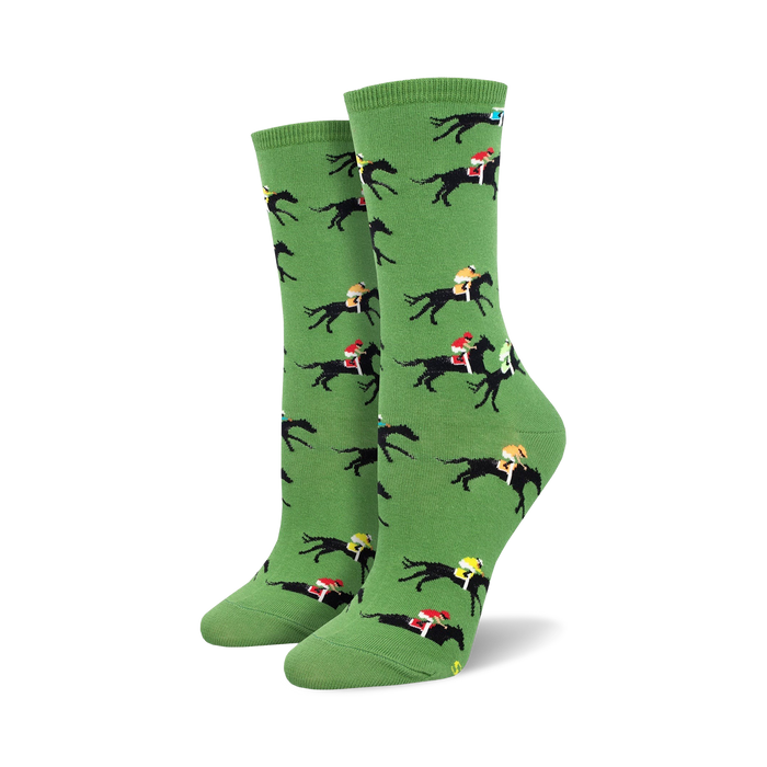 black horses with red, blue, and yellow jockeys on a green background. crew length socks for women. theme: horse racing.   }}