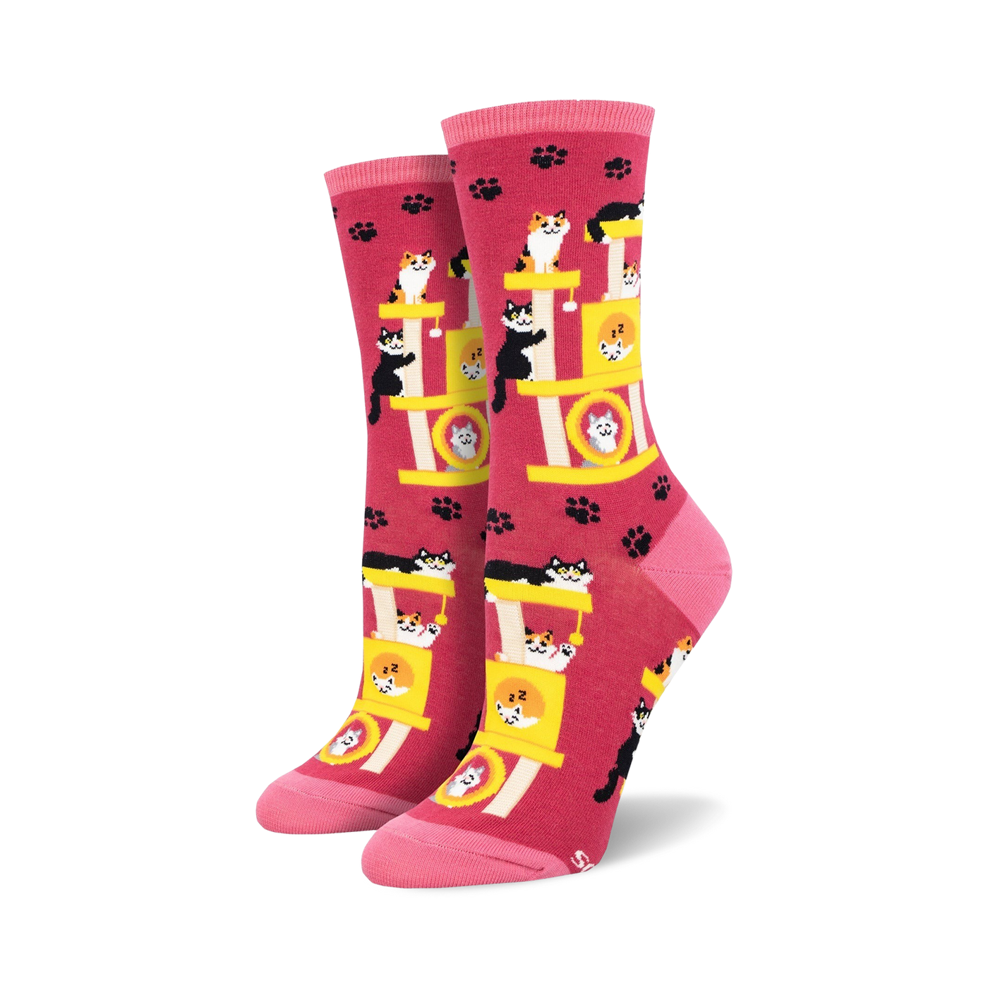 Crew socks in pink featuring a repeating pattern of cats playing on a yellow cat tree. Pink paw prints are scattered across the background.