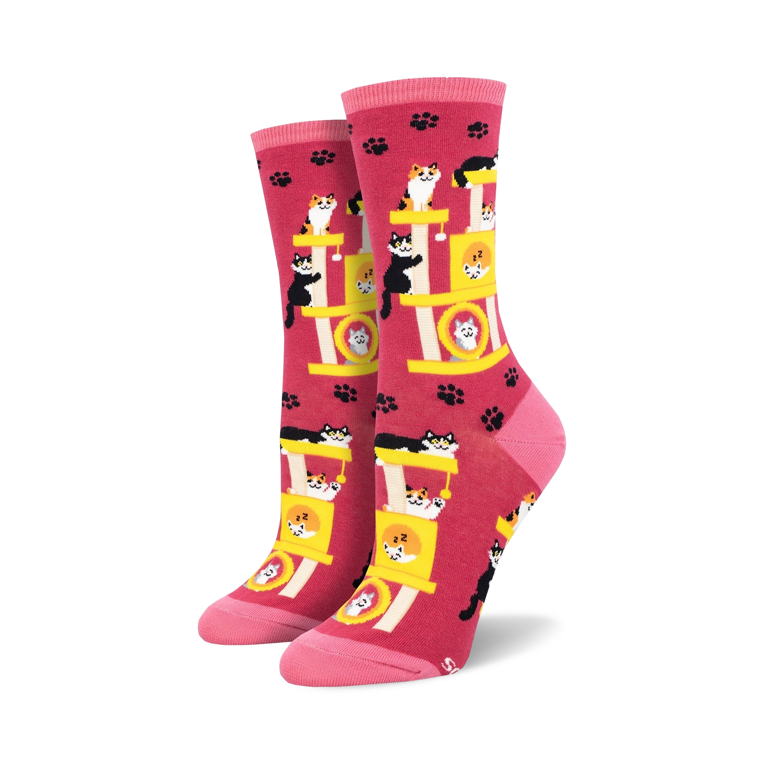 Crew socks in pink featuring a repeating pattern of cats playing on a yellow cat tree. Pink paw prints are scattered across the background.