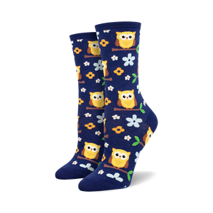 dark blue crew socks with yellow owls, orange feet, white bellies, perched on branches with green leaves and yellow flowers   