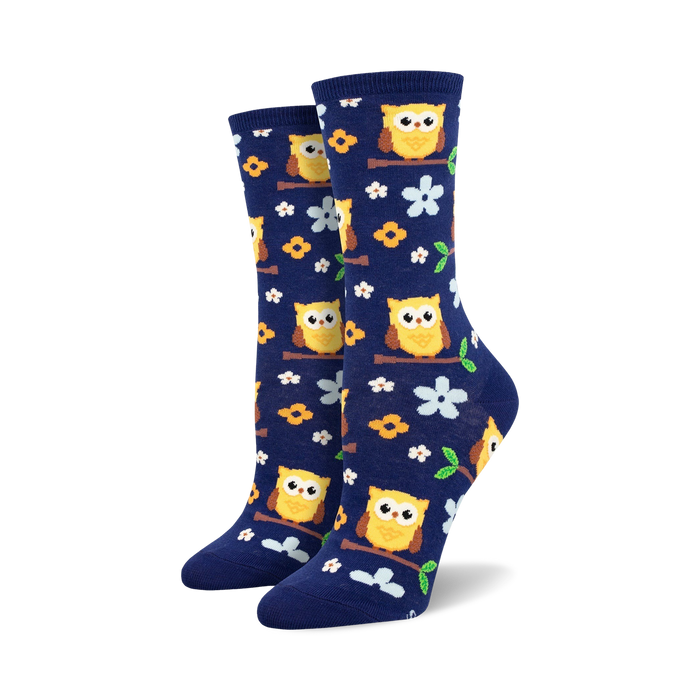 dark blue crew socks with yellow owls, orange feet, white bellies, perched on branches with green leaves and yellow flowers   