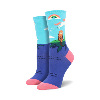 blue and pink crew socks featuring bigfoot on an island with a rainbow, unicorn, waves and clouds.  