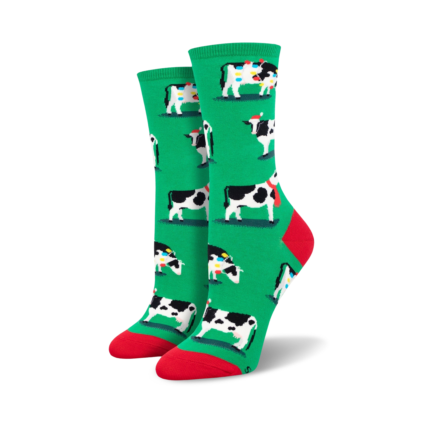 Pair of women's crew socks. Green background with a repeating pattern of black and white cows wearing Christmas hats and scarves.