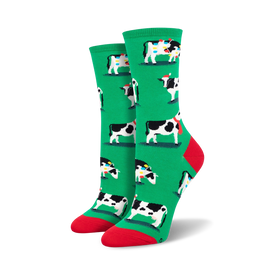 womens crew socks feature christmas themed black and white cows wearing santa hats and scarves surrounded by red and yellow christmas lights.  