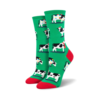 womens crew socks feature christmas themed black and white cows wearing santa hats and scarves surrounded by red and yellow christmas lights.  