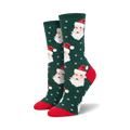 A pair of women's crew socks in green, red, and white. The socks feature a repeating pattern of Santa's face and snowflakes.
