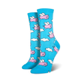 Pair of women's crew socks in light blue. The socks feature a whimsical pattern of pink pigs with wings flying amidst white clouds.