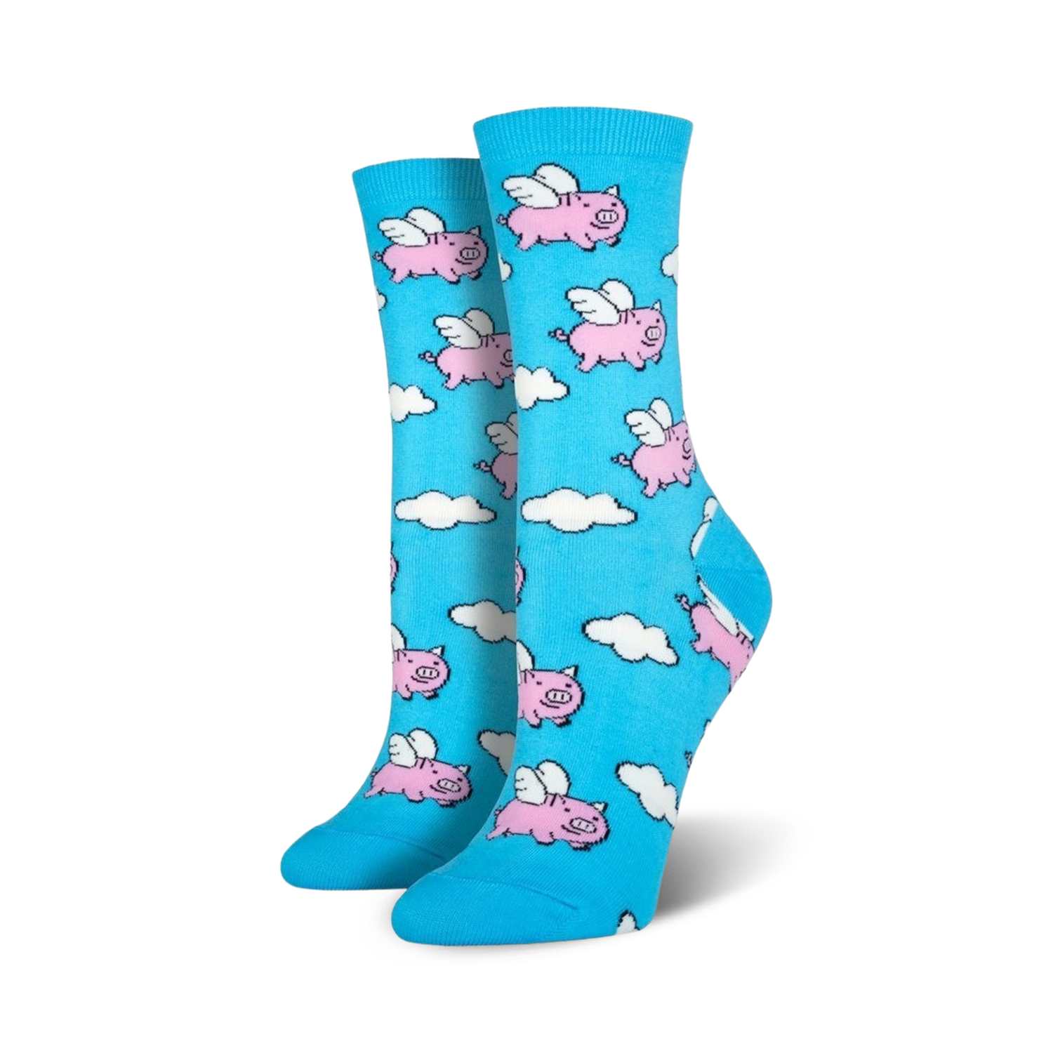 Pair of women's crew socks in light blue. The socks feature a whimsical pattern of pink pigs with wings flying amidst white clouds.