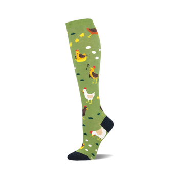 the chicken ranch socks are an amusing pair of socks that feature a pattern of chickens, chicks, eggs, and grassy patches on an olive green background. socks that are knee-high and have a black heel and toe.