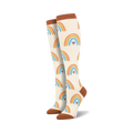 Pair of knee-high cream socks with repeating orange, blue, and purple rainbow heart patterns. Terracotta cuffs, heels, and toes.