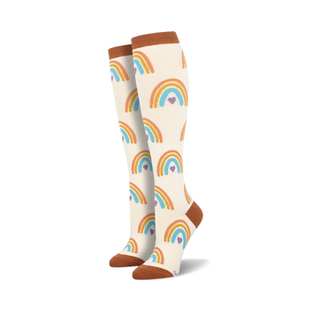 boho rainbow knee high socks for women: vibrant rainbows and hearts adorn these white socks with light brown toes and heels.  