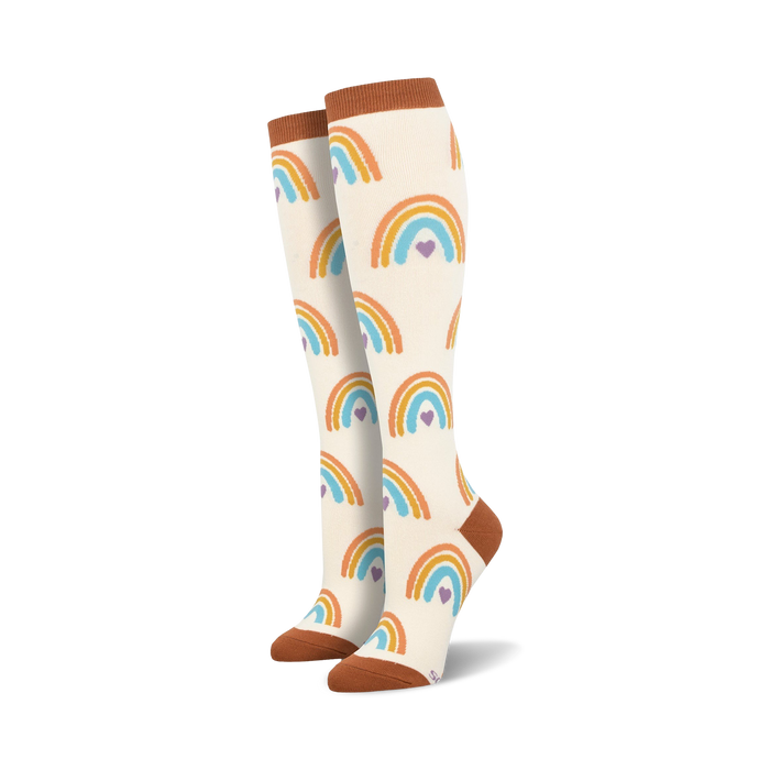 boho rainbow knee high socks for women: vibrant rainbows and hearts adorn these white socks with light brown toes and heels.   }}