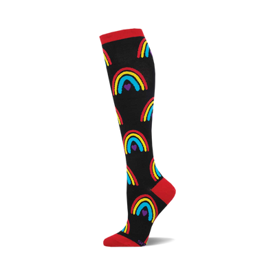 Single black knee-high sock with red cuff, heel, toe, patterned with yellow, red, blue rainbows and purple hearts.
