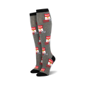 Pair of grey knee-high socks with a repeating pattern of red cans that say "Whoop Ass" and a wrench.  Black cuff.