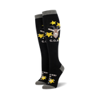 Pair of black knee-high socks with a goat graphic, yellow stars, and 'G.O.A.T.' text. Gray cuff.