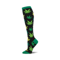 A single knee-high sock with a black background and a pattern of green and yellow marijuana leaves. The cuff is green.