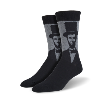 black socks with a light gray pattern of abraham lincoln's face on a dark gray toe, heel, and top.  