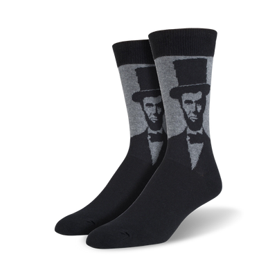 black socks with a light gray pattern of abraham lincoln's face on a dark gray toe, heel, and top.  