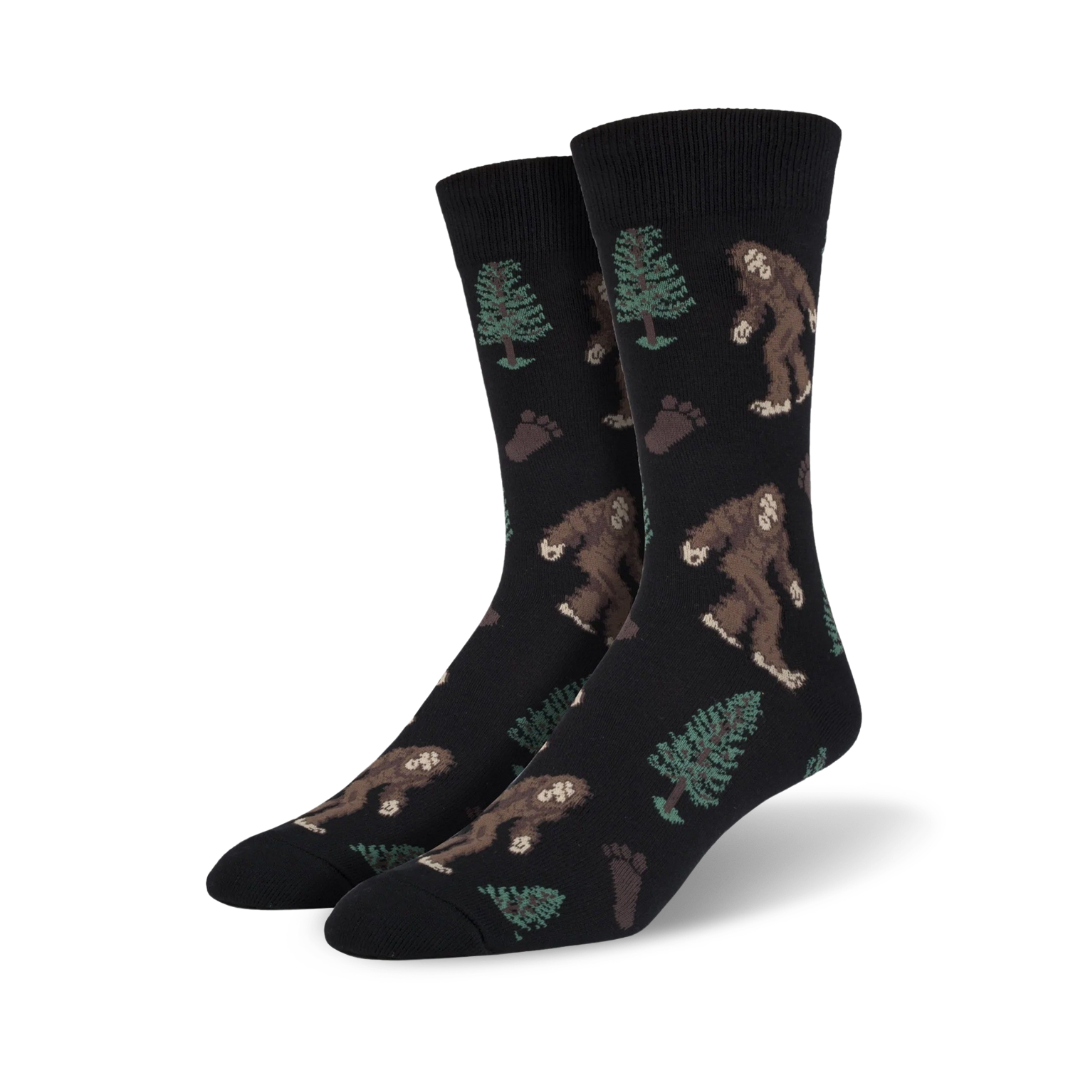 Pair of crew socks; black background with brown Bigfoot, green trees, and brown footprints. Fun, whimsical design.