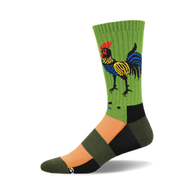 the folk art rooster socks are dark green with a multicolored rooster on the front. the rooster has red, yellow, blue, and black feathers. there is orange and black at the toe and heel of the sock and black at the top of the sock.