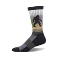 Crew socks in dark gray, beige, and white, featuring a Bigfoot walking through a forest.  Green trees and a subtle striped pattern.