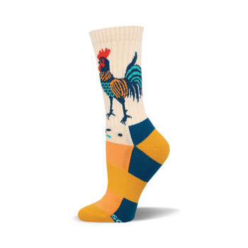 the folk art rooster socks are white, yellow, orange, green, and blue. they have a pattern of roosters wearing sombreros. the roosters have red and green tail feathers.