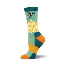 the green sock has a pattern of yellow and white hexagons. there is a bee on the green part of the sock above the honeycomb pattern. the toe and heel of the sock are orange. the top of the sock is dark teal with two thin yellow stripes.