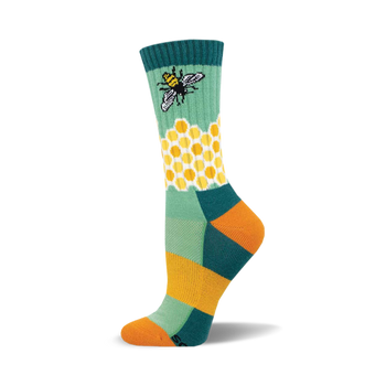 the green sock has a pattern of yellow and white hexagons. there is a bee on the green part of the sock above the honeycomb pattern. the toe and heel of the sock are orange. the top of the sock is dark teal with two thin yellow stripes.