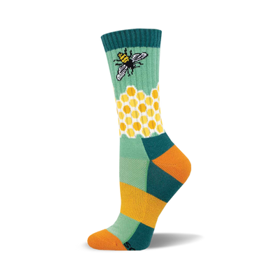 the green sock has a pattern of yellow and white hexagons. there is a bee on the green part of the sock above the honeycomb pattern. the toe and heel of the sock are orange. the top of the sock is dark teal with two thin yellow stripes.