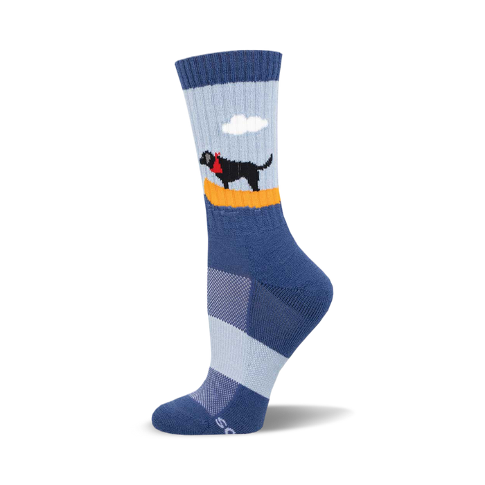 socks that are blue with a black dog wearing a red bandana around its neck. the dog is standing on a surfboard with a single white cloud above it. the surfboard is yellow and has orange stripes on the top and bottom. }}